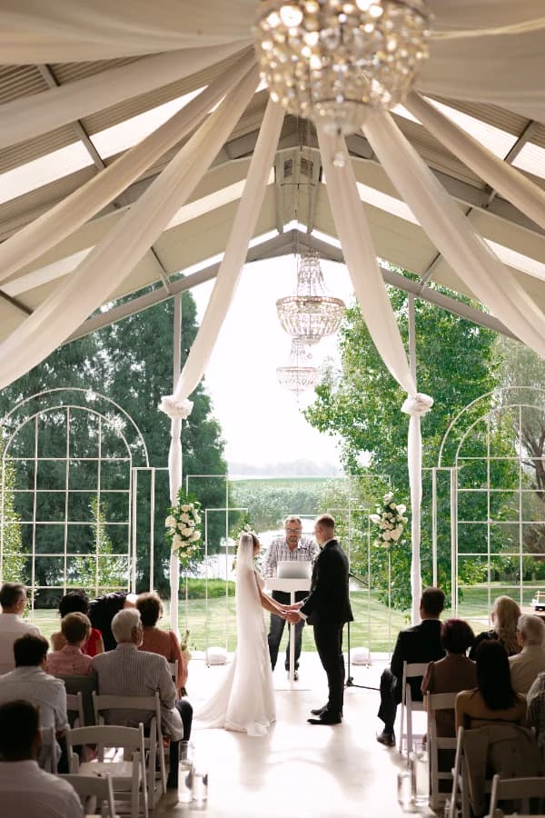 Guests seated for an outdoor ceremony at Riverside Estate chapel
