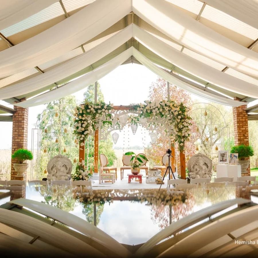 Wedding ceremony setup in the Open Air Chapel surrounded by willow trees